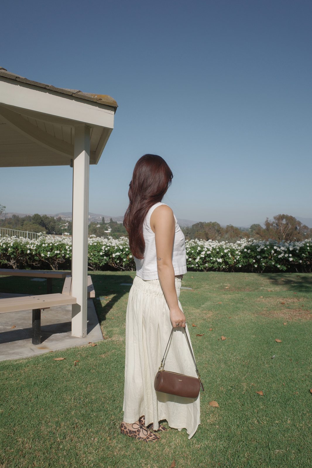 White Tank + Cream Linen Maxi Skirt with a Coach Bag